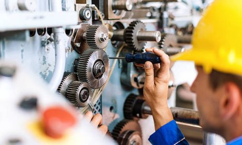 Blue collar worker or engineer working in industrial production plant, dealing with metal processing, hydraulic machinery, production lines and other processing industry machines. Image taken in Serbia, Europe.